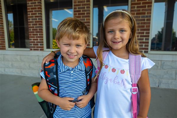 girl student and girl student with backpacks on